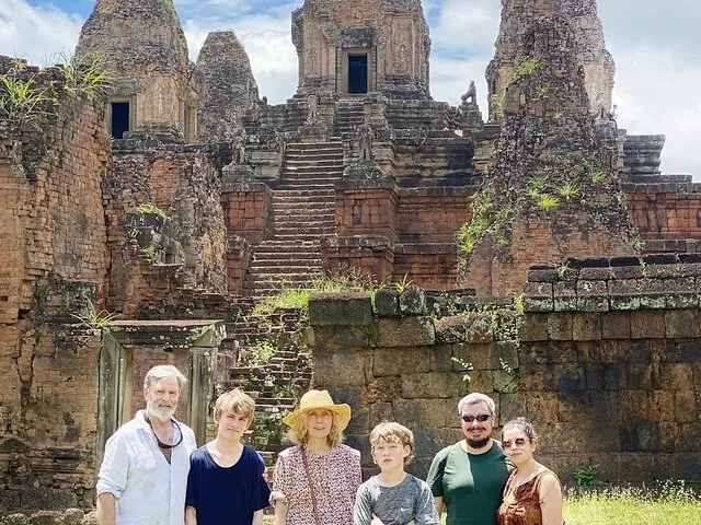 A family of five standing together in front of the Pre Rup temple.